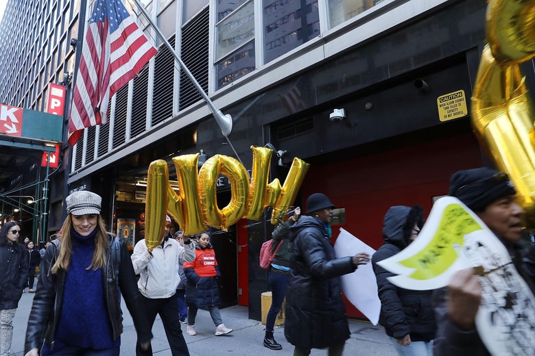 Activists participate in a march and rally outside of three financial companies in New York.